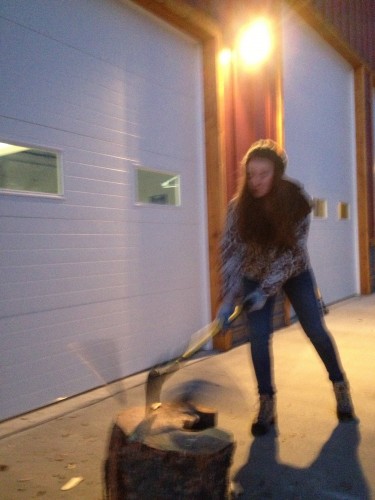 Lauren chopping wood in Idaho to keep her yurt warm