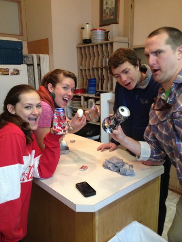 Isabelle, the only Chemistry student, witnesses gas laws and effects of temperature and pressure by crushing hot aluminum cans in cold water, and using heat to put a hardboiled egg inside a glass bottle. (taken at Depot on Idaho campus)