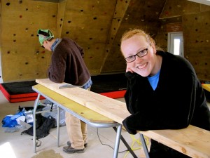 Brady cuts the wood with the help of Roxy the stabilizer